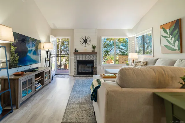 a living room with furniture flat screen tv and a fireplace