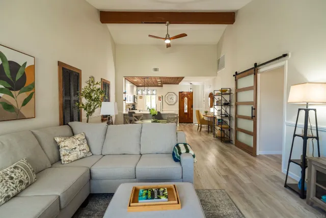 a living room with furniture and wooden floor