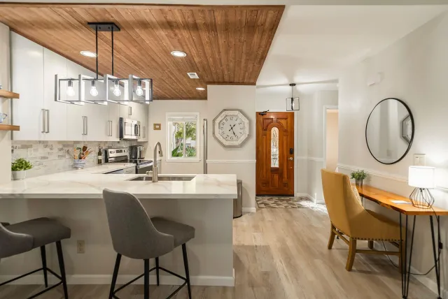 a very nice looking dining room with kitchen island a table and chairs