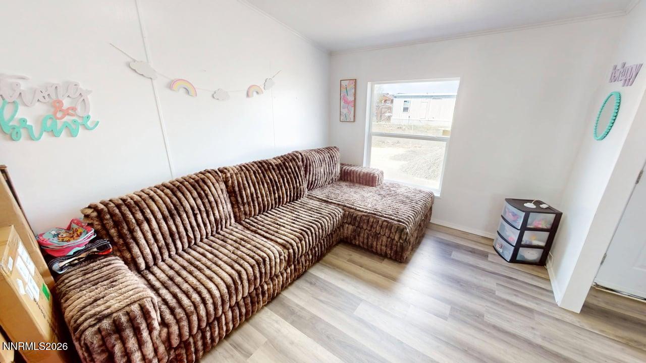 102 Bastian Road Battle Mountain, NV 89820 - Photo 12 of 38 a bedroom with furniture and a wooden floor