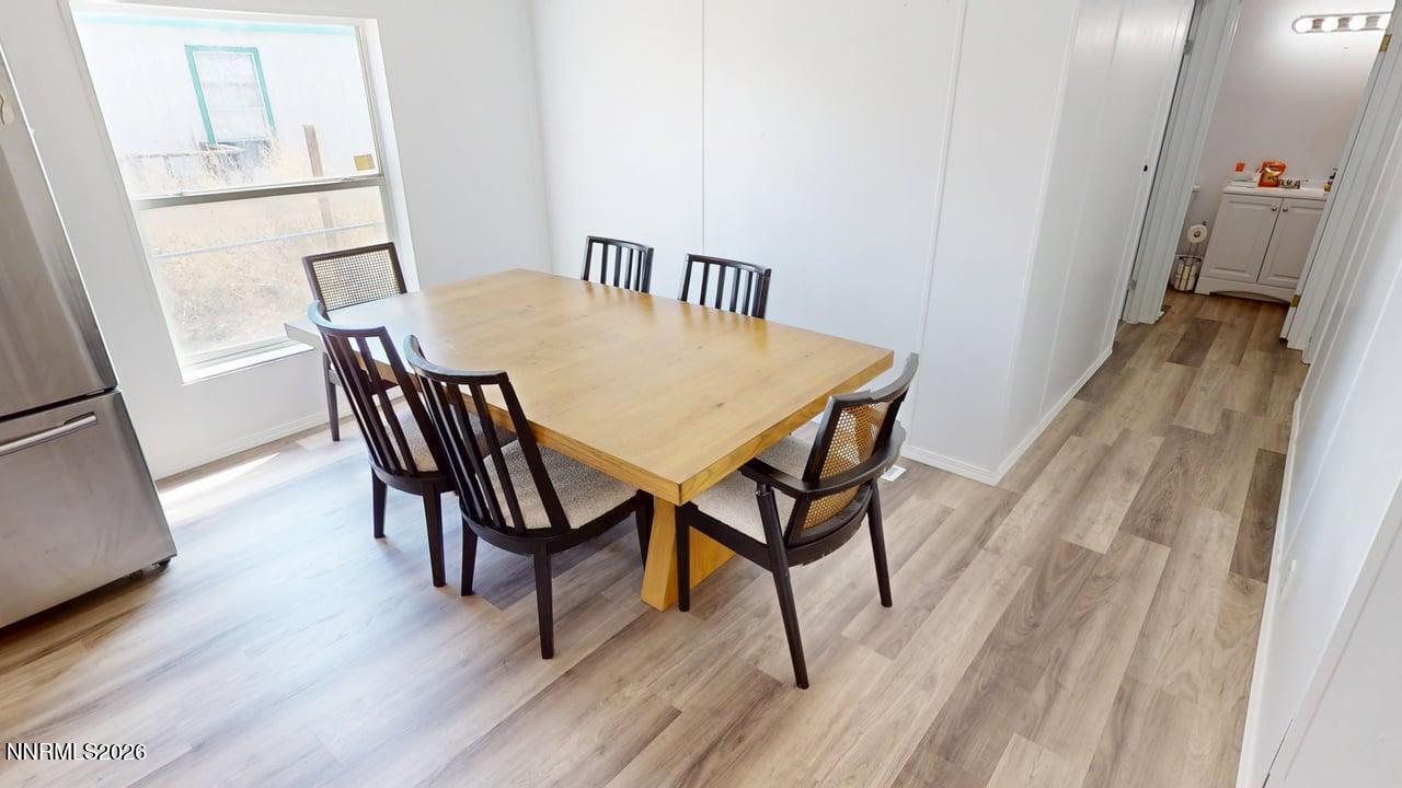 102 Bastian Road Battle Mountain, NV 89820 - Photo 13 of 38 a view of a dining room with furniture and wooden floor