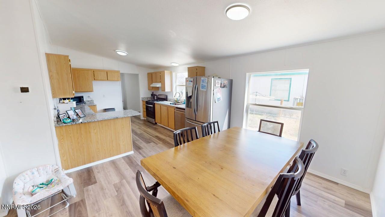102 Bastian Road Battle Mountain, NV 89820 - Photo 15 of 38 a view of a dining room with furniture and a wooden floor