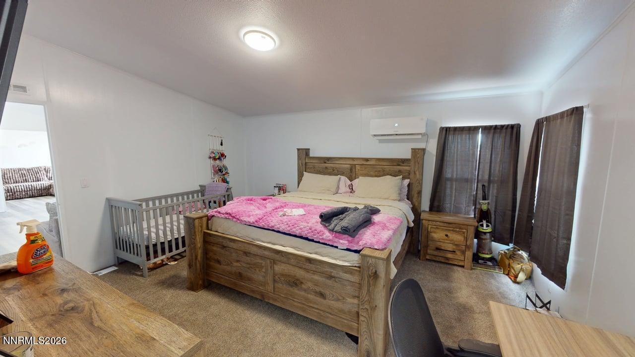 102 Bastian Road Battle Mountain, NV 89820 - Photo 22 of 38 a bedroom with a bed and a window