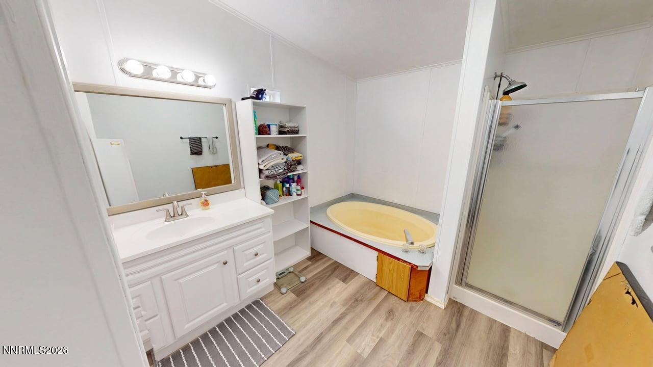 102 Bastian Road Battle Mountain, NV 89820 - Photo 26 of 38 a bathroom with a tub sink and mirror