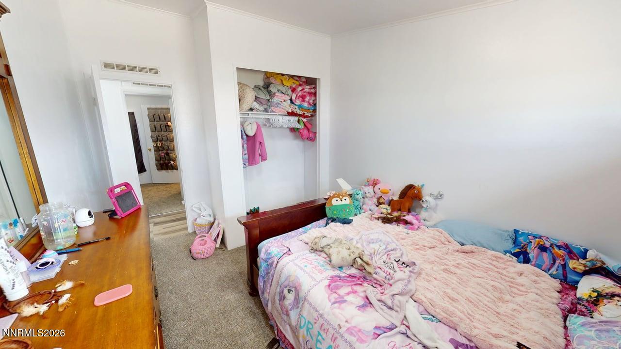 102 Bastian Road Battle Mountain, NV 89820 - Photo 29 of 38 a bedroom with a bed and wooden floor