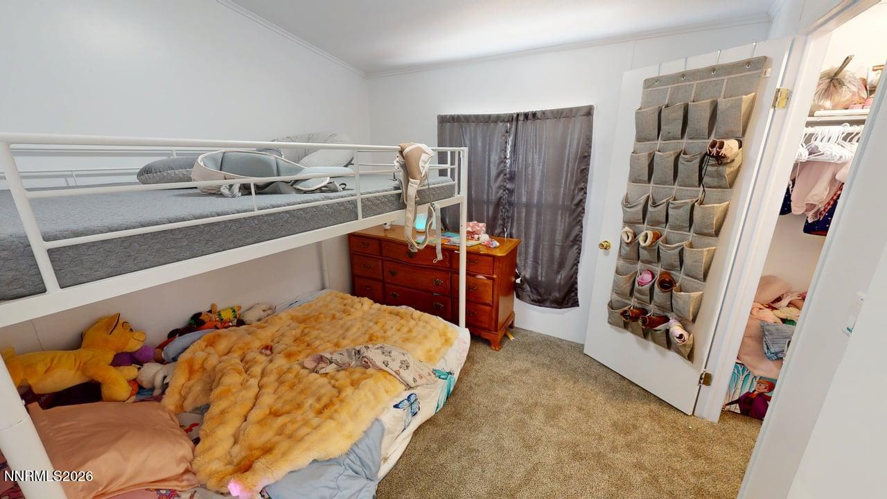 102 Bastian Road Battle Mountain, NV 89820 - Photo 31 of 38 a bed sitting in a bedroom next to a cabinet