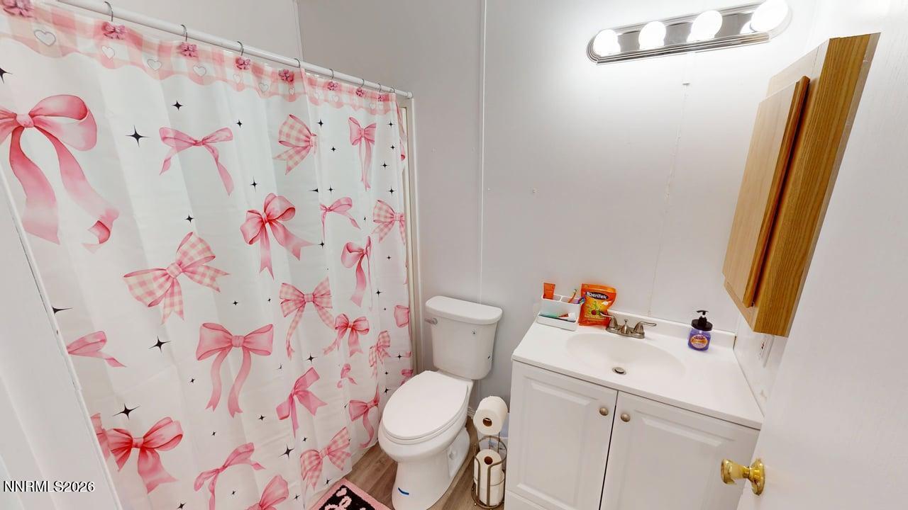 102 Bastian Road Battle Mountain, NV 89820 - Photo 33 of 38 a white toilet sitting next to a sink and a curtain