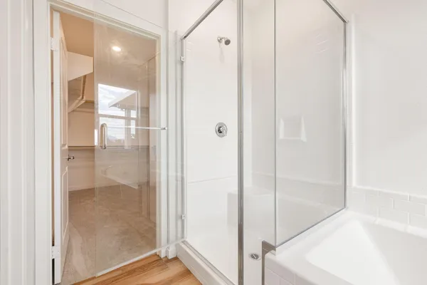 a bathroom with a glass shower door