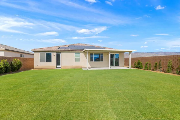 a view of a house with backyard and garden