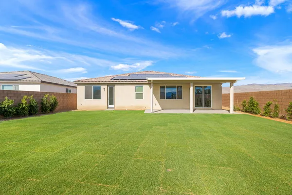 a view of a house with backyard and garden