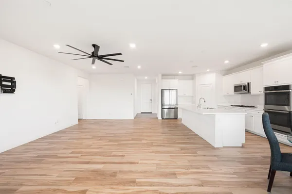 a view of a kitchen with a sink and wooden floor