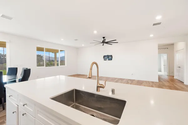 a kitchen with a sink and a hard wood floor