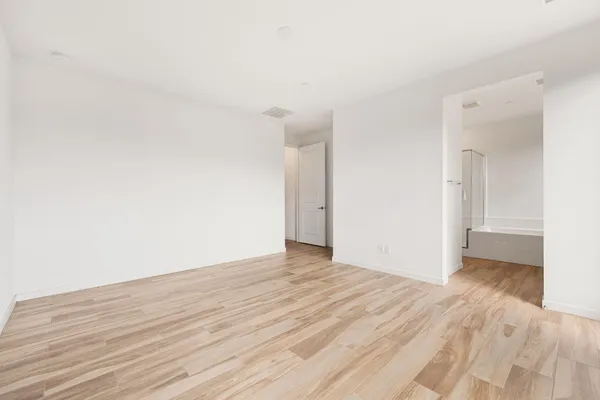 a view of an empty room and wooden floor