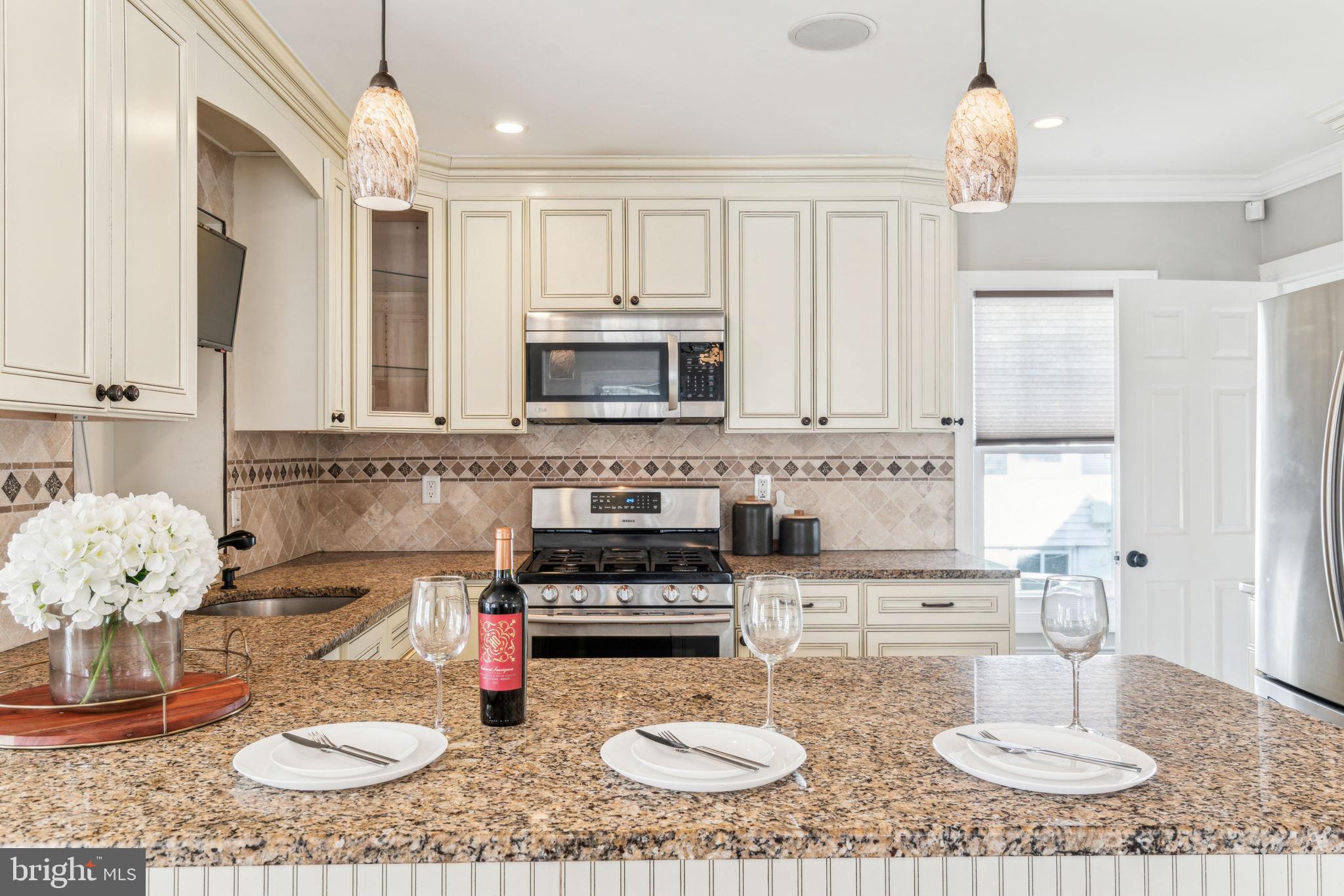 77 Concord Avenue Hamilton, NJ 08619 - Photo 15 of 45 a kitchen with a stove a sink and cabinets