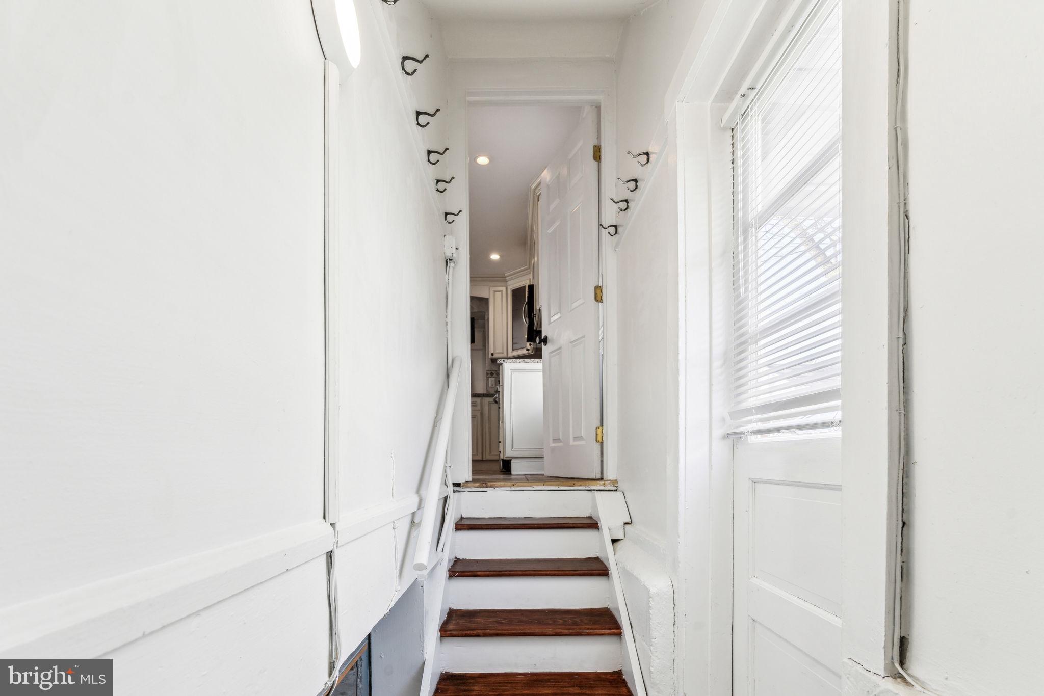 77 Concord Avenue Hamilton, NJ 08619 - Photo 19 of 45 a view of a hallway with white walls and wooden floor