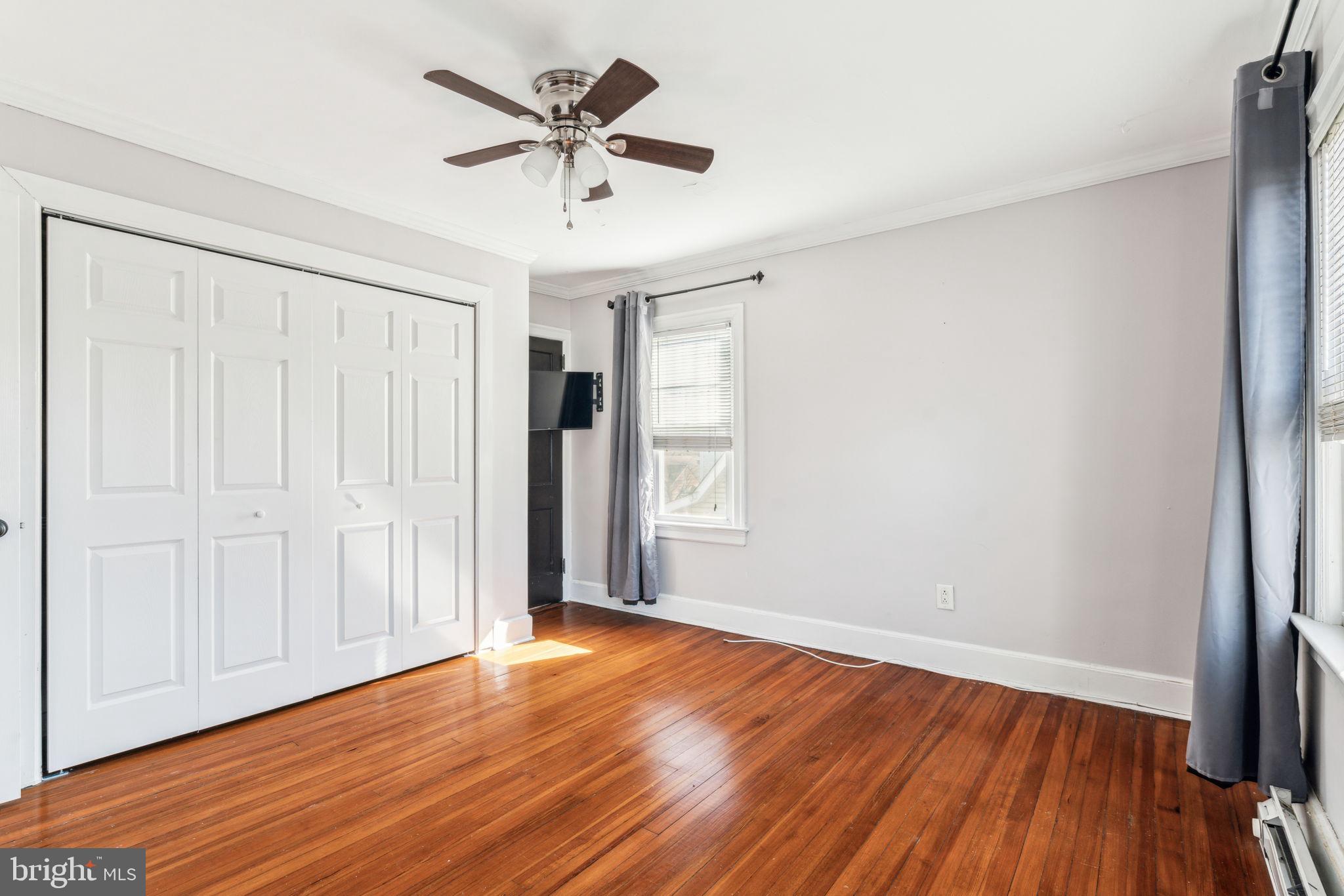 77 Concord Avenue Hamilton, NJ 08619 - Photo 35 of 45 an empty room with wooden floor and windows