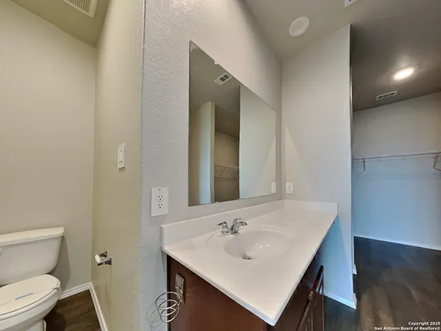 a bathroom with a sink toilet and mirror