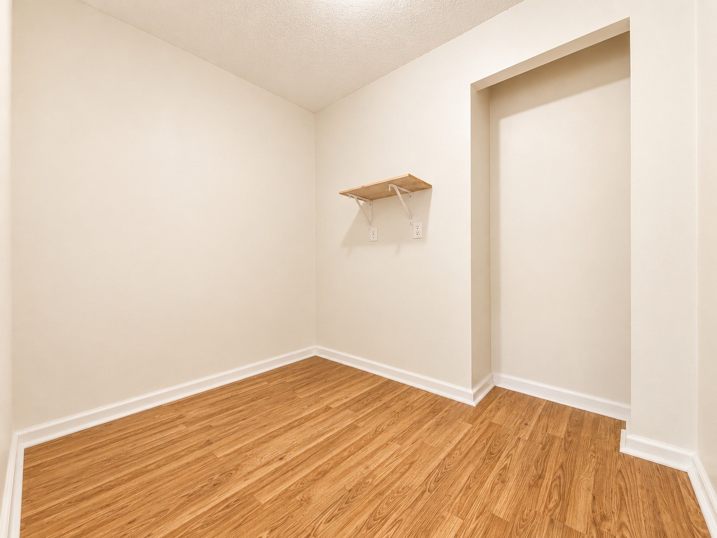 316 Riley Road Clute, TX 77531 - Photo 18 of 21 Bright, versatile home office or storage room featuring sleek hardwood style floors and neutral walls, perfect for a home office or cozy retreat.