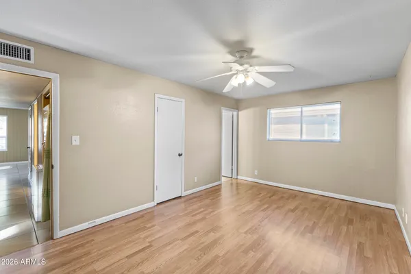 a view of an empty room with wooden floor