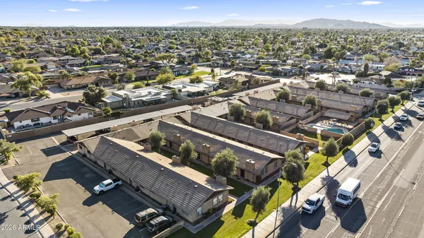 an aerial view of residential houses with city view