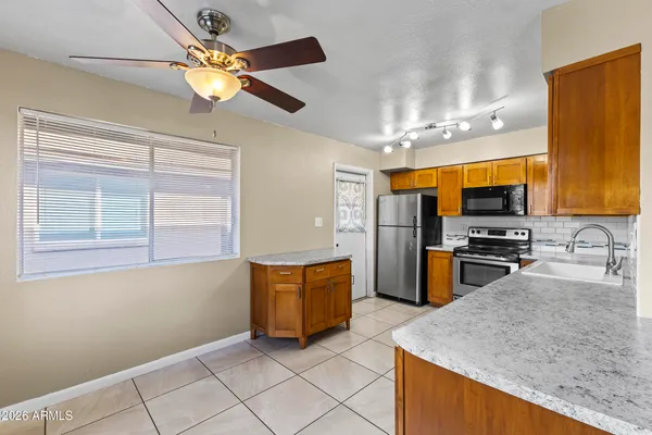 a kitchen with stainless steel appliances granite countertop a stove and a sink