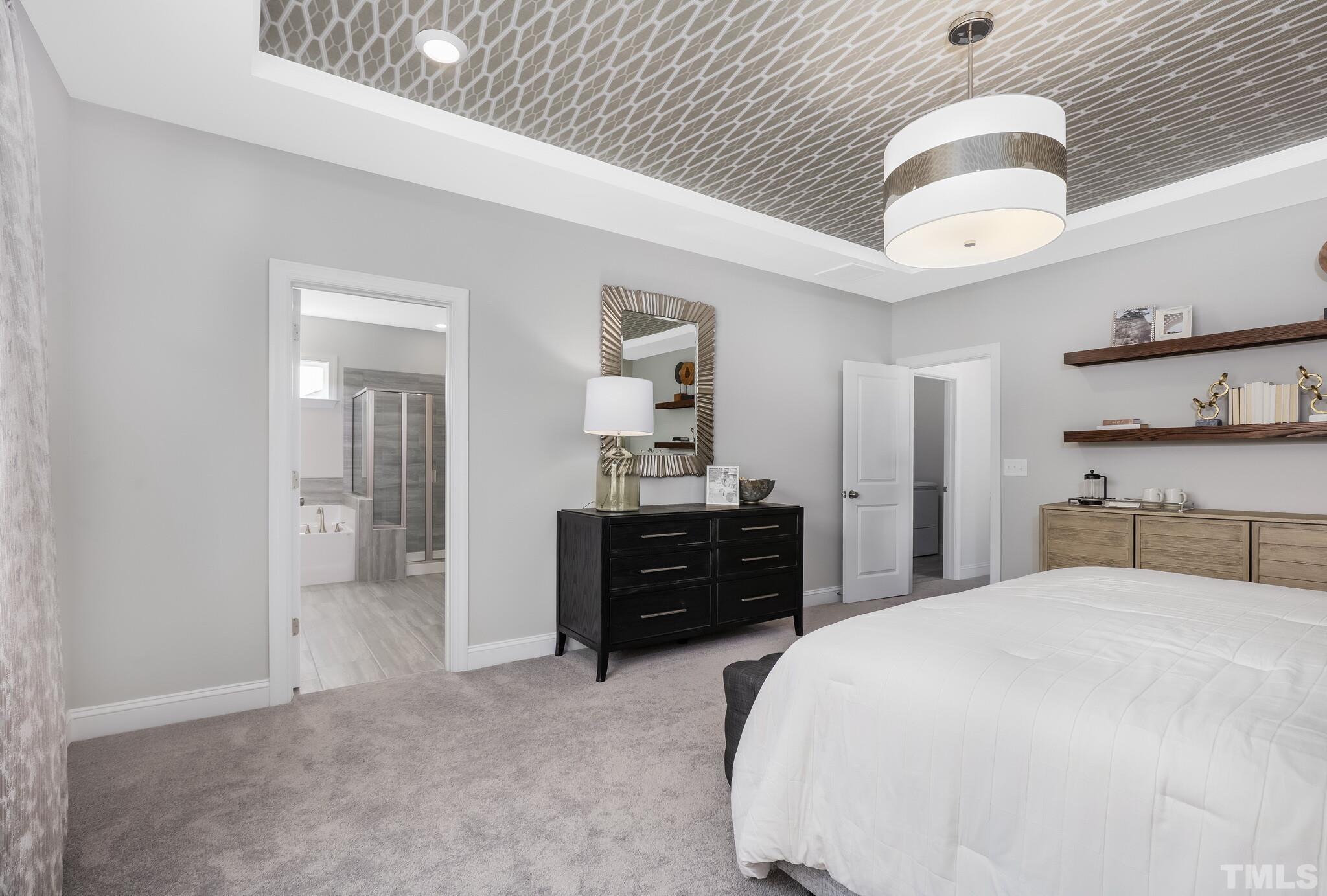 3937 Mount Moran Road Raleigh, NC 27616 - Photo 16 of 18 a bedroom with a bed and a chandelier