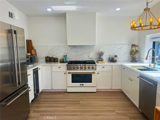 a kitchen with a stove sink and refrigerator