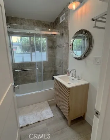 a bathroom with a sink a mirror and a bathtub
