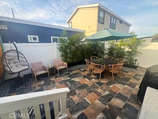a building outdoor space with patio furniture and potted plants