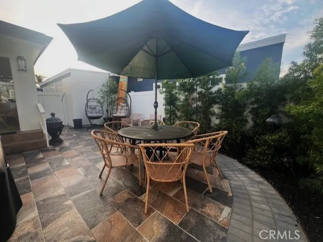 a patio with a patio table and chairs
