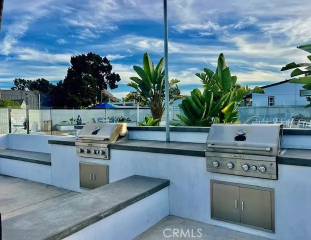 a view of kitchen with stove and refrigerator
