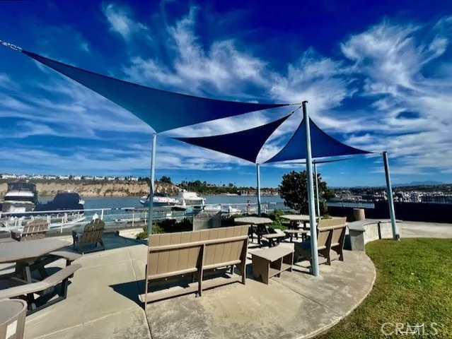 a view of a patio with a table and chairs under an umbrella