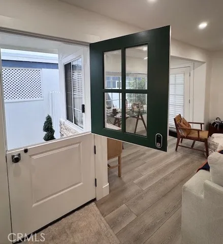 a living room with furniture and large windows