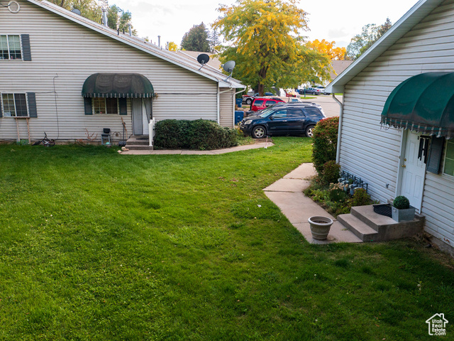 190 West 700 North Logan, UT 84321 - Photo 21 of 51 View of green lawn with entry steps