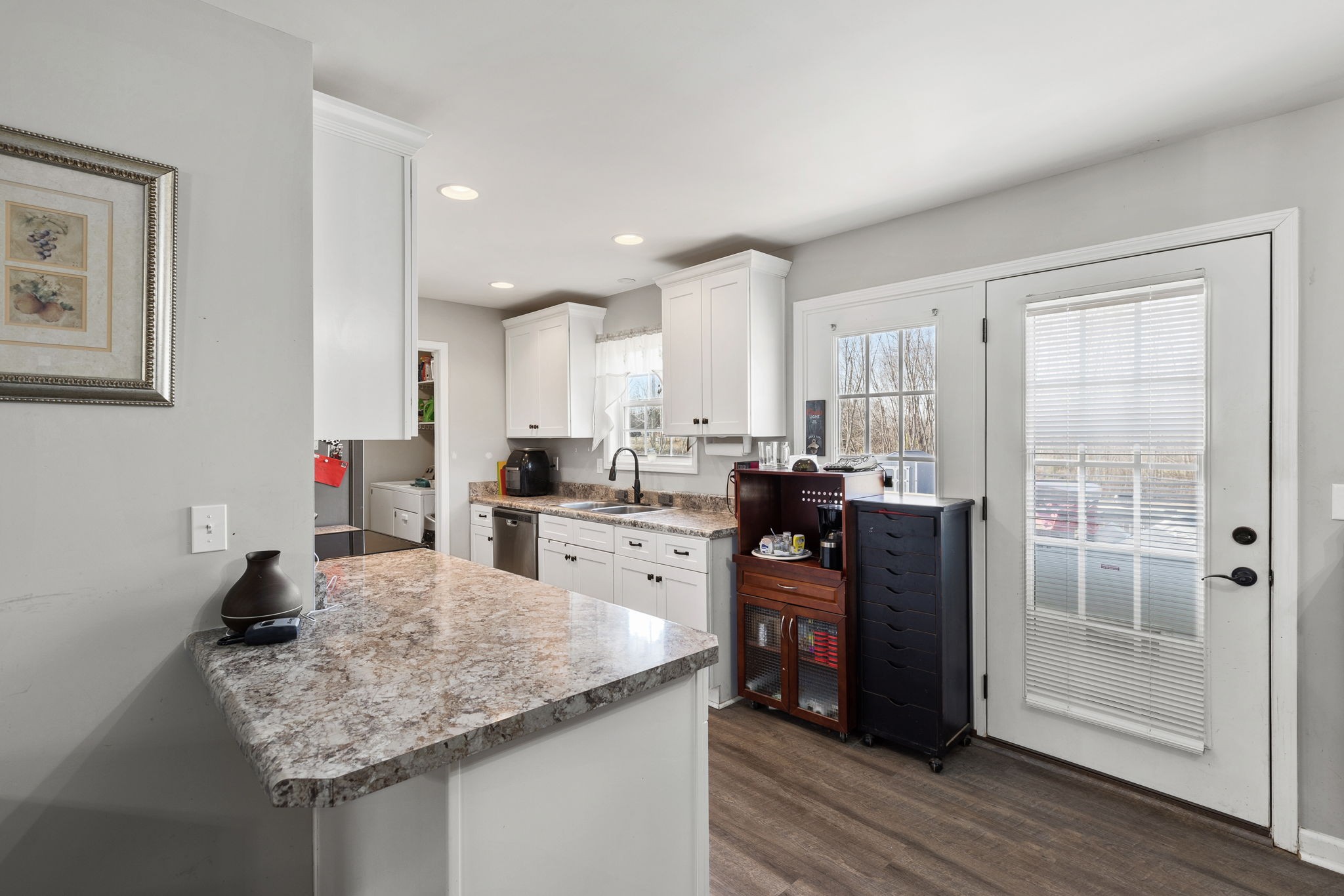 6491 Highway 161 Springfield, TN 37172 - Photo 11 of 32 a kitchen with stainless steel appliances granite countertop a sink counter space and wooden floor
