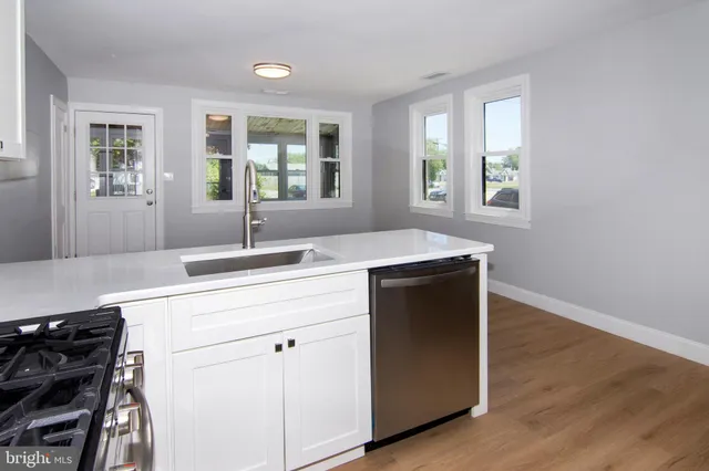 a kitchen with a sink stove and cabinets