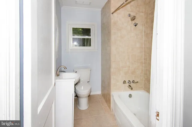 a bathroom with a toilet and a bathtub