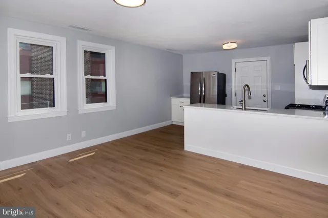 a view of a kitchen cabinets and wooden floor