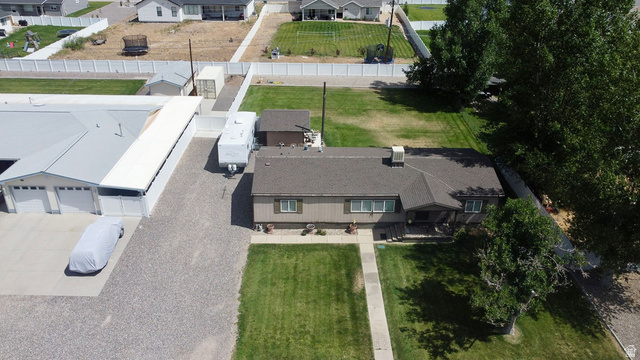 855 East 300 N Street Beaver, UT 84713 - Photo 41 of 44 Expansive gravel driveway leading to a multi-bay garage with overhead doors