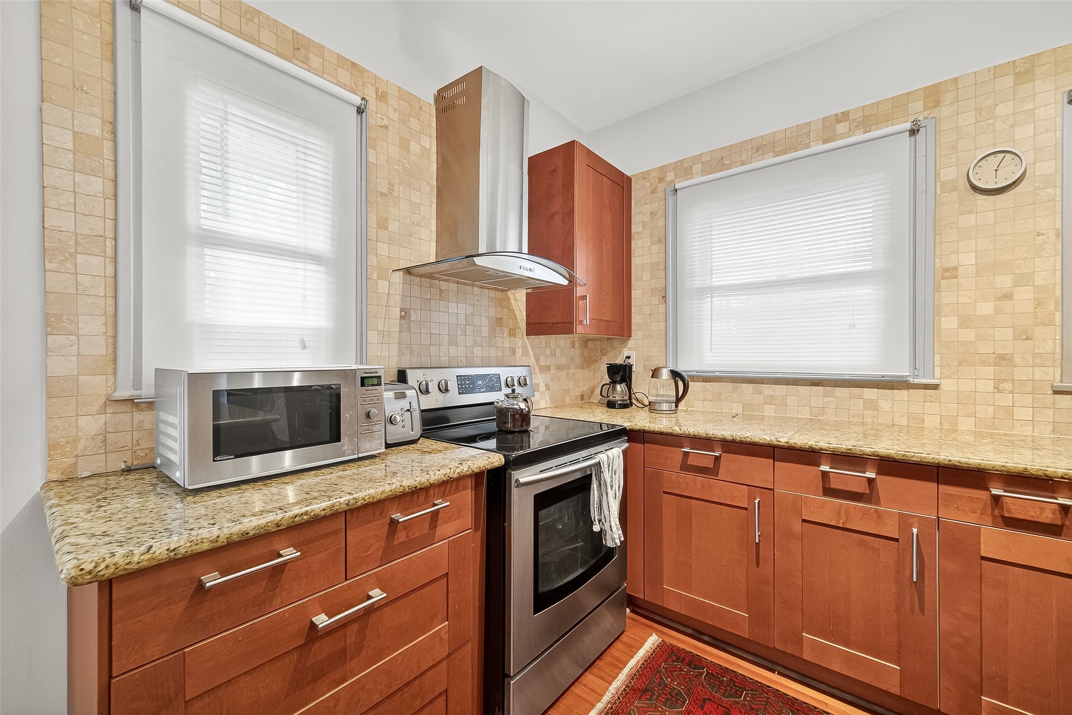 1612 West Alabama Street, Unit ABCD Houston, TX 77006 - Photo 38 of 50 a kitchen with stainless steel appliances granite countertop a stove a sink and a microwave