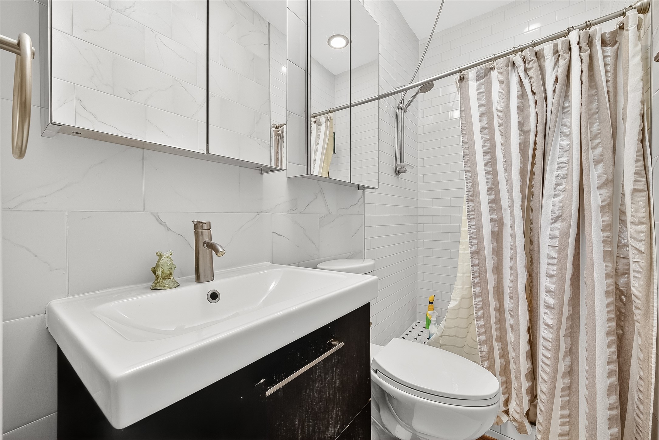 1612 West Alabama Street, Unit ABCD Houston, TX 77006 - Photo 46 of 50 a bathroom with a sink a toilet and shower curtain