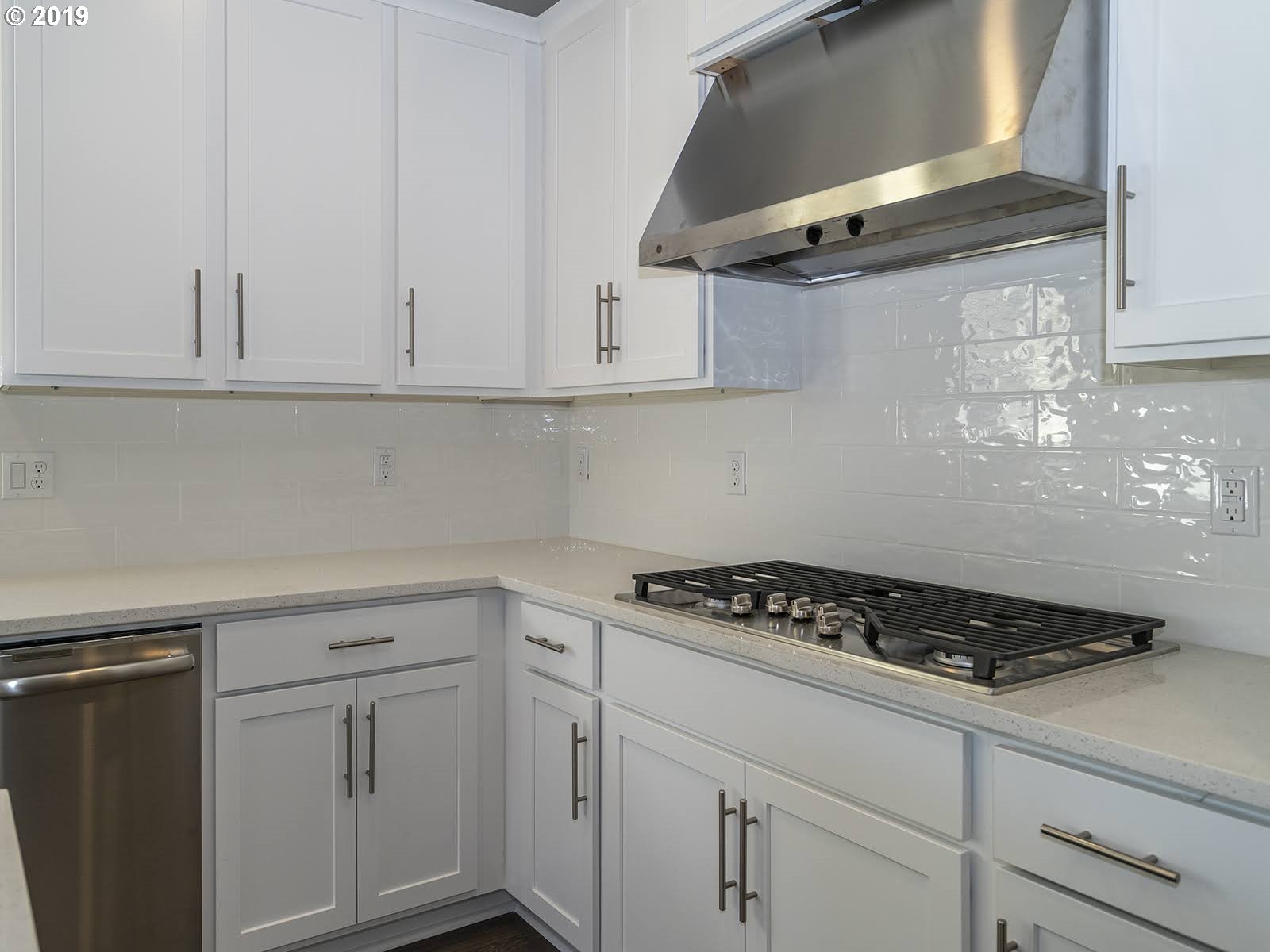 4826 South 17th Way Ridgefield, WA 98642 - Photo 8 of 19 a kitchen with white cabinets and stove