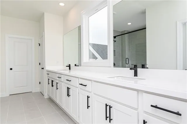 a bathroom with double sink and a mirror