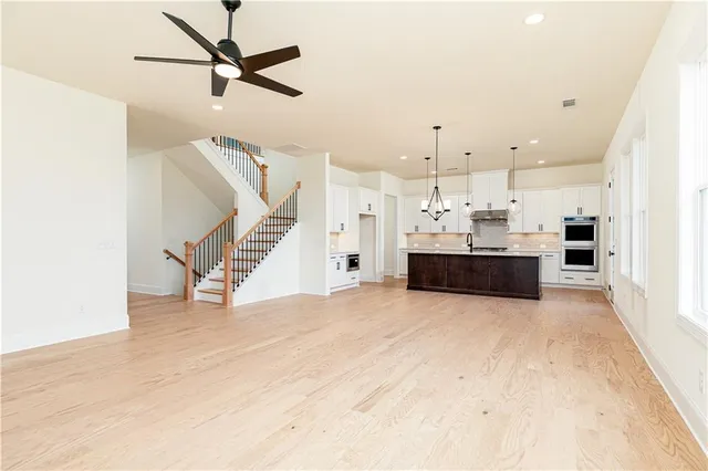 a view of kitchen and kitchen with microwave