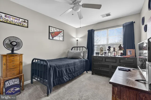 a bedroom with furniture and a flat screen tv