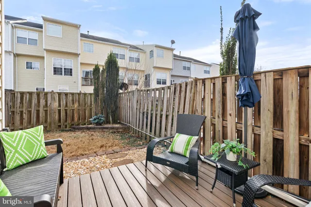 a view of a patio with couches table and chairs and potted plants