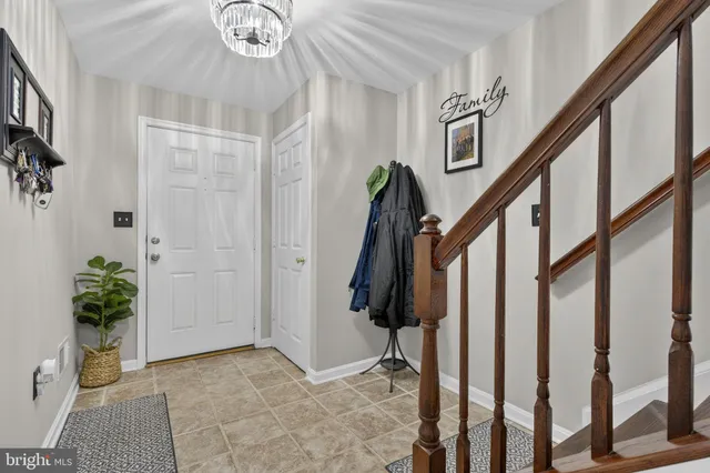 a view of entryway with wooden floor and stairs