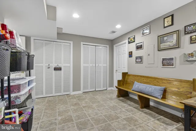 a spacious bedroom with a bed and a flat screen tv