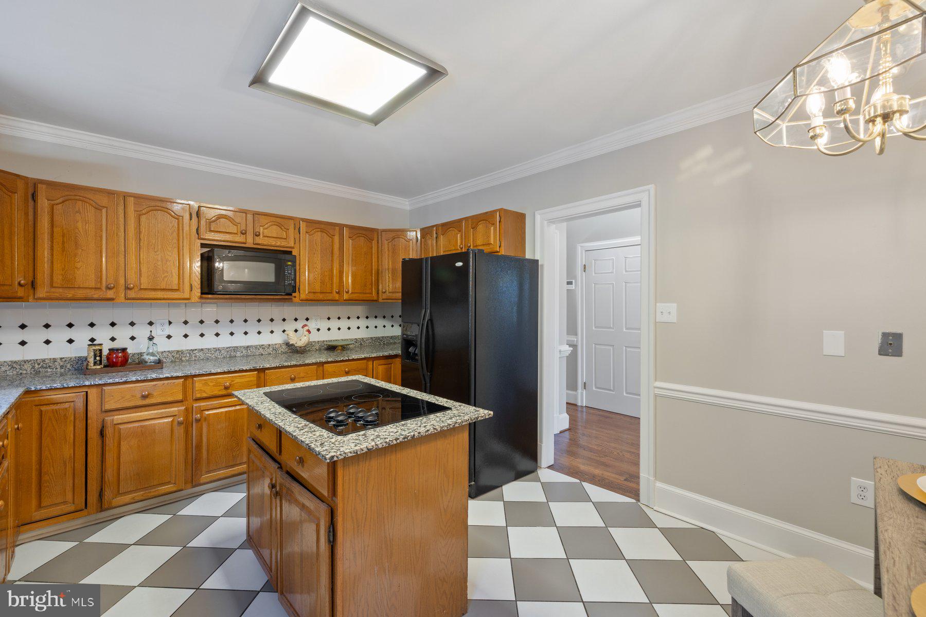 7005 Beacon Light Road Riverdale, MD 20737 - Photo 13 of 45 a kitchen with stainless steel appliances granite countertop a refrigerator and a sink