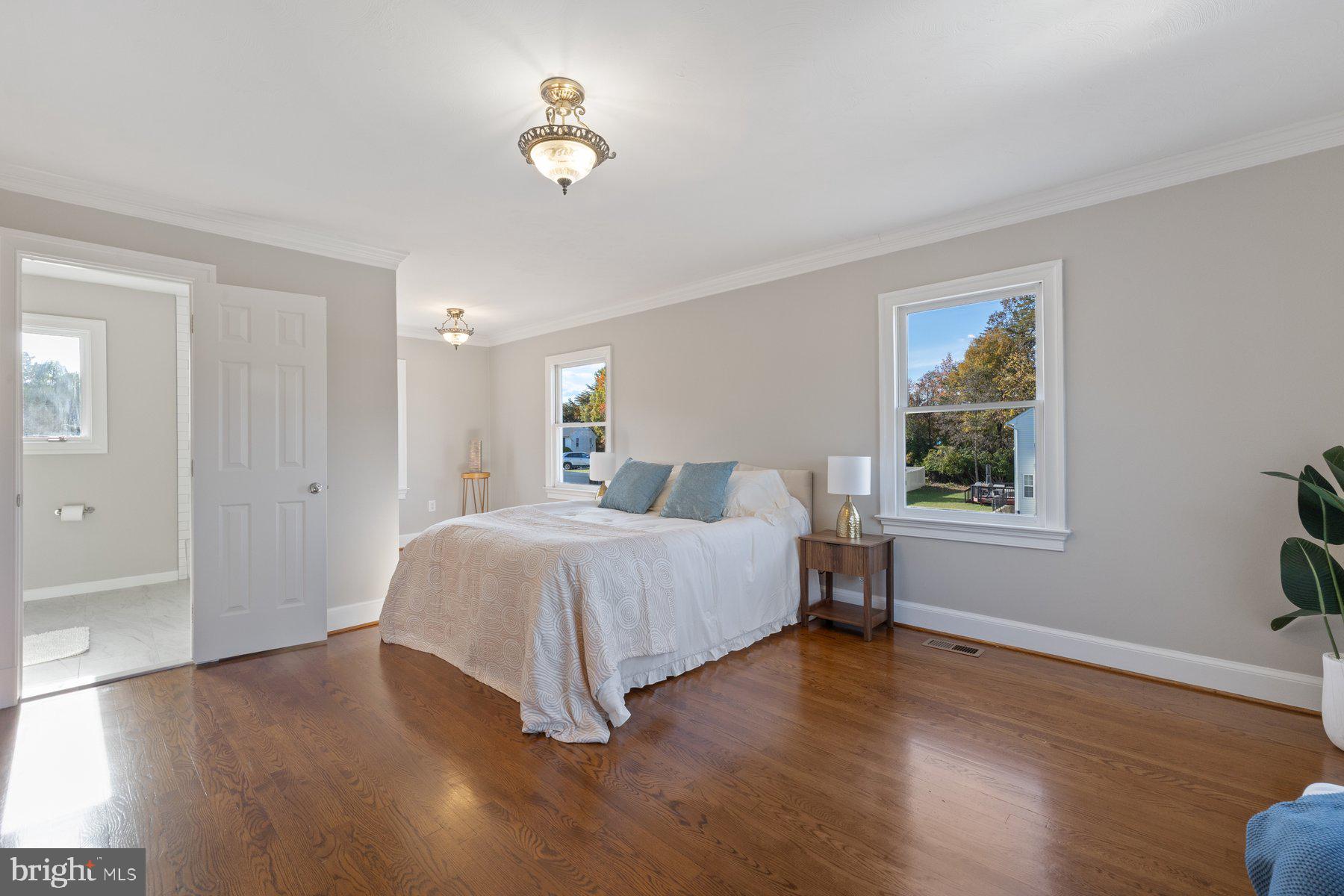 7005 Beacon Light Road Riverdale, MD 20737 - Photo 24 of 45 a spacious bedroom with a bed and a window